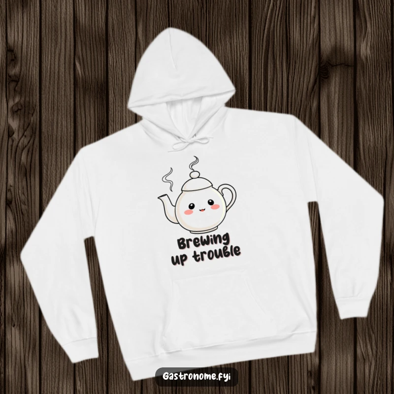 Funny Hoodie featuring a curious teapot character exuding merrily swirling steam, offering warmth and humor as a gift.