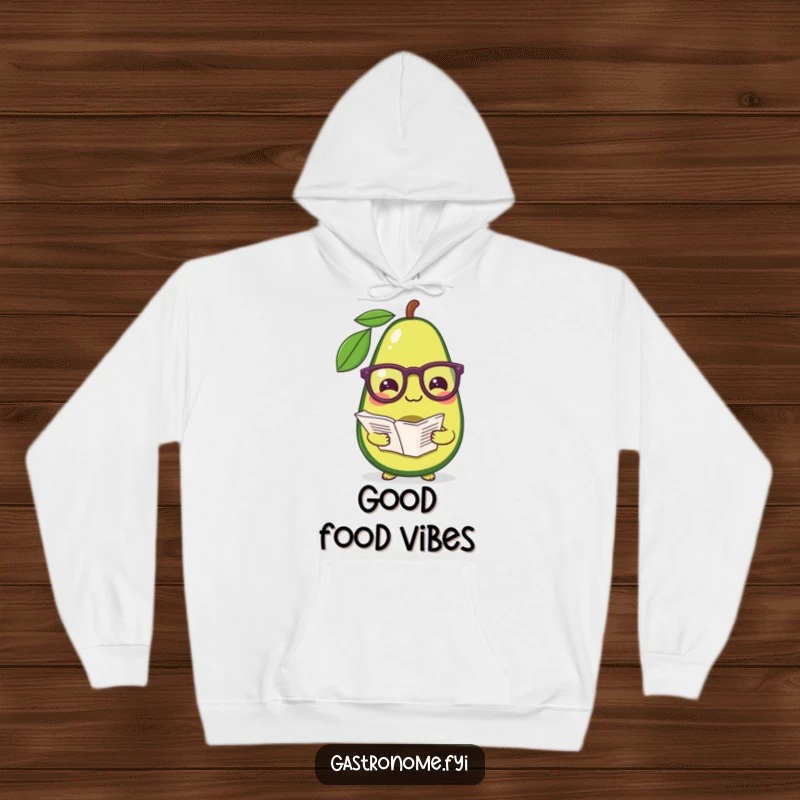 Funny hoodie featuring a pleased avocado in reading glasses, clutching a recipe, embodying kitchen wit and warmth.