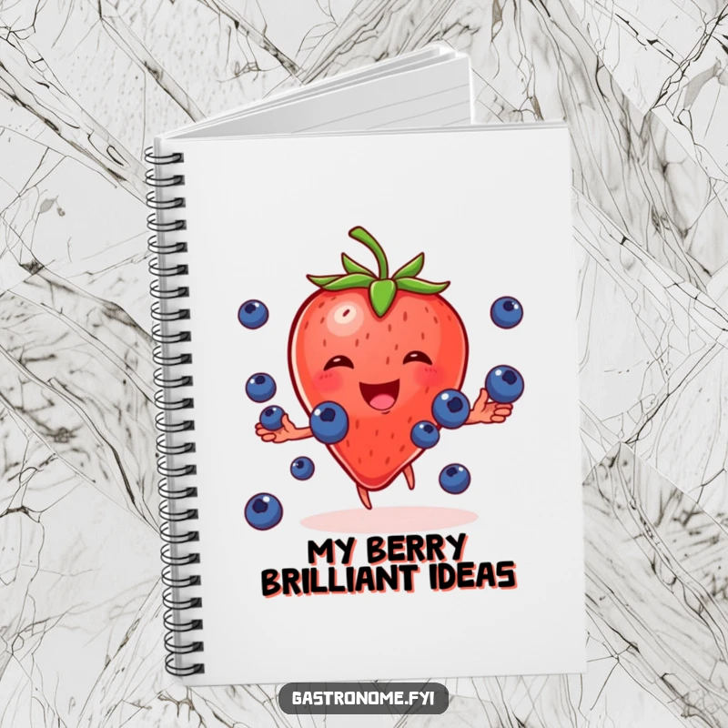 Funny notebook with a cheerful strawberry character gleefully juggling tiny blueberries, ideal for note-taking and recipe recording.