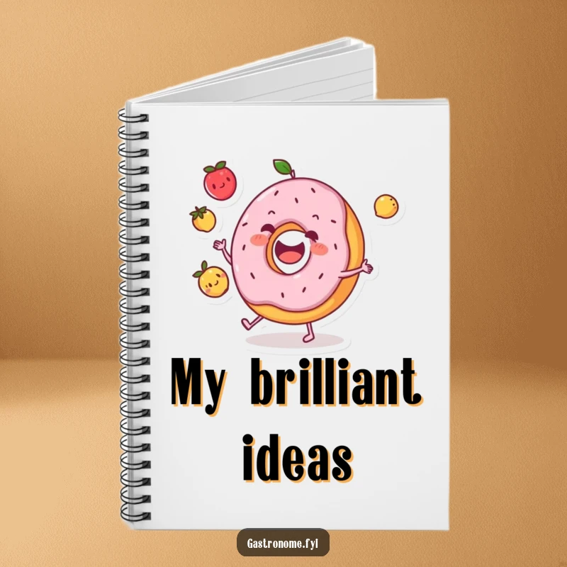 Funny donut character notebook happily juggling three small fruits, ideal for capturing thoughts with a touch of humor.
