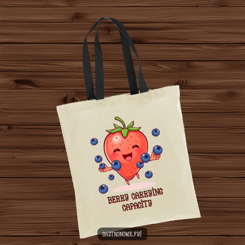 Funny tote bag showcasing a cheerful strawberry character gleefully juggling tiny blueberries, perfect for carrying groceries and more.